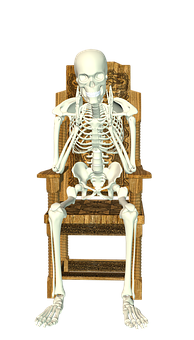 A Skeleton Sitting In A Chair