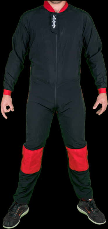A Man Wearing A Black And Red Jumpsuit