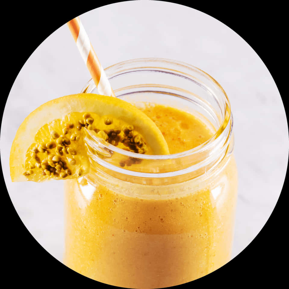 A Glass Jar With A Straw And A Yellow Smoothie