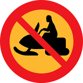 A Sign With A Person On A Snowmobile
