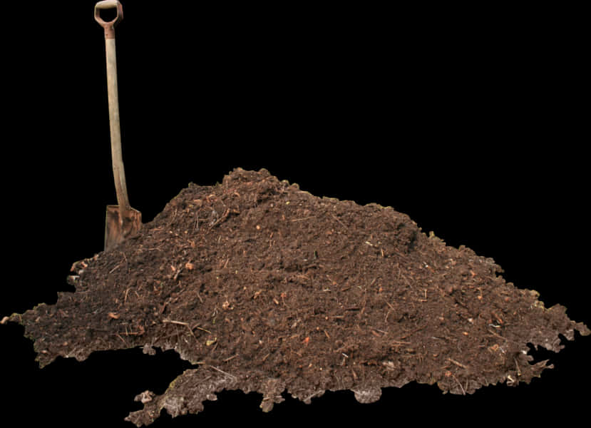 A Pile Of Dirt With A Shovel