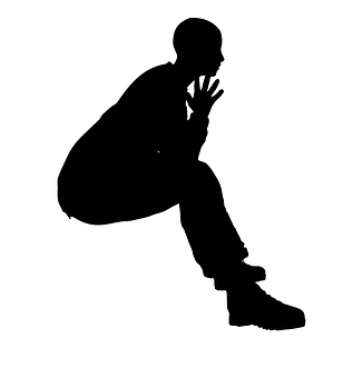 A Silhouette Of A Person Sitting