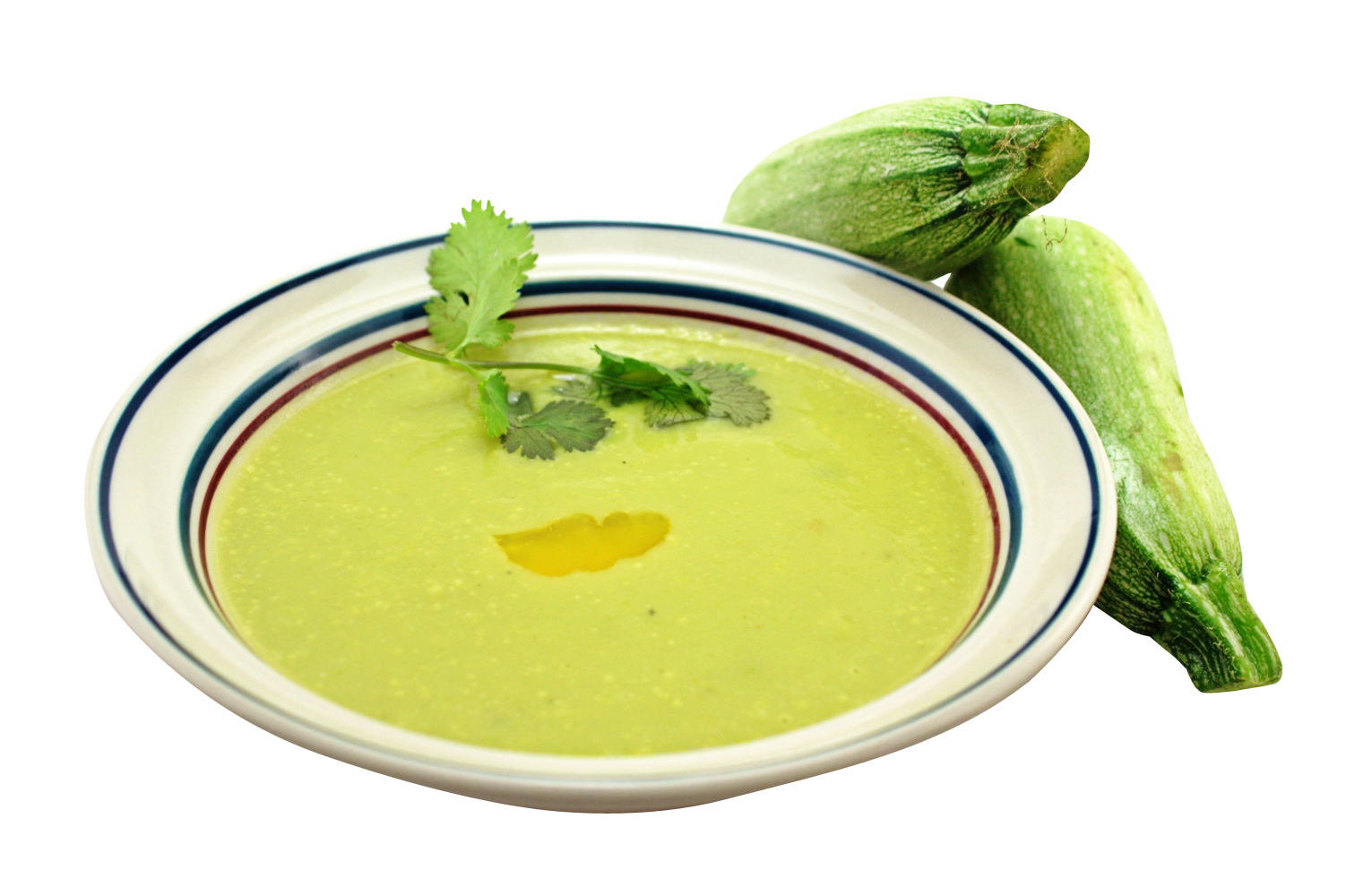 A Bowl Of Green Soup Next To Zucchini