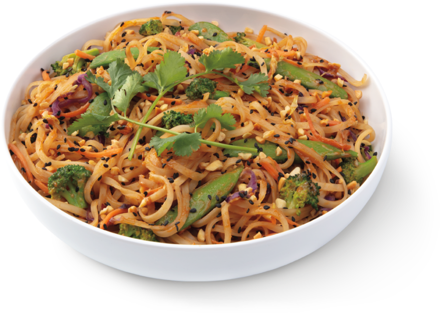 A Bowl Of Noodles With Vegetables And Herbs