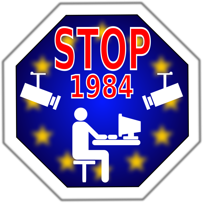 A Stop Sign With A Person Sitting At A Desk