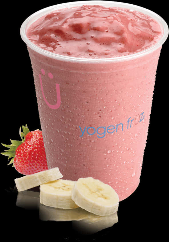 A Cup Of Pink Smoothie With Strawberries And Bananas