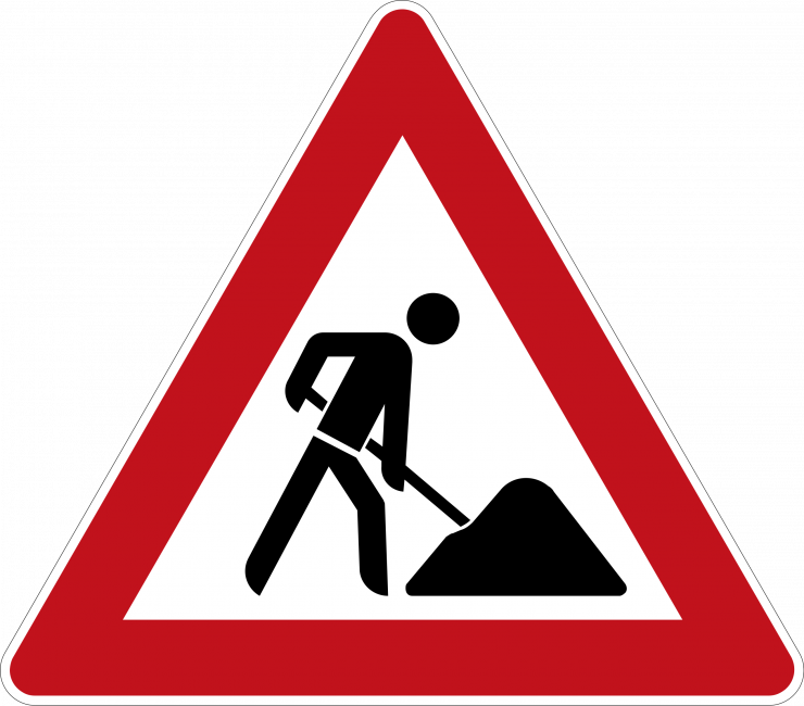 A Red And White Triangle Sign With A Man Digging A Hole
