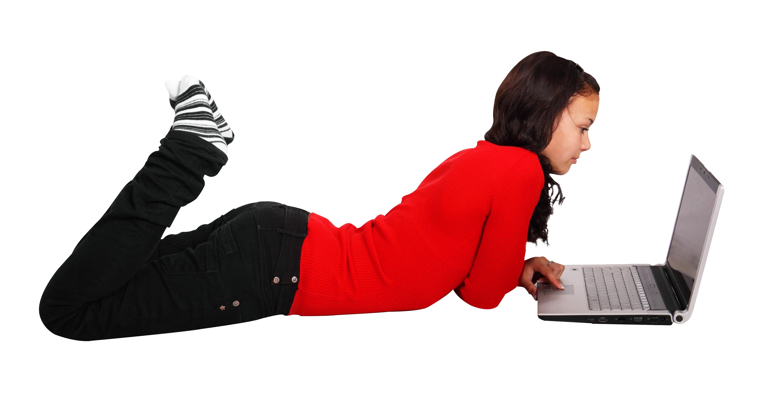 A Woman Lying On Her Stomach Using A Laptop