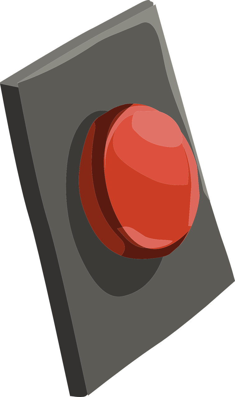 A Red Button On A Gray Surface