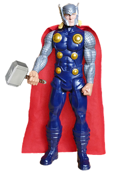 A Toy Figure With A Red Cape And A Blue And Gold Body