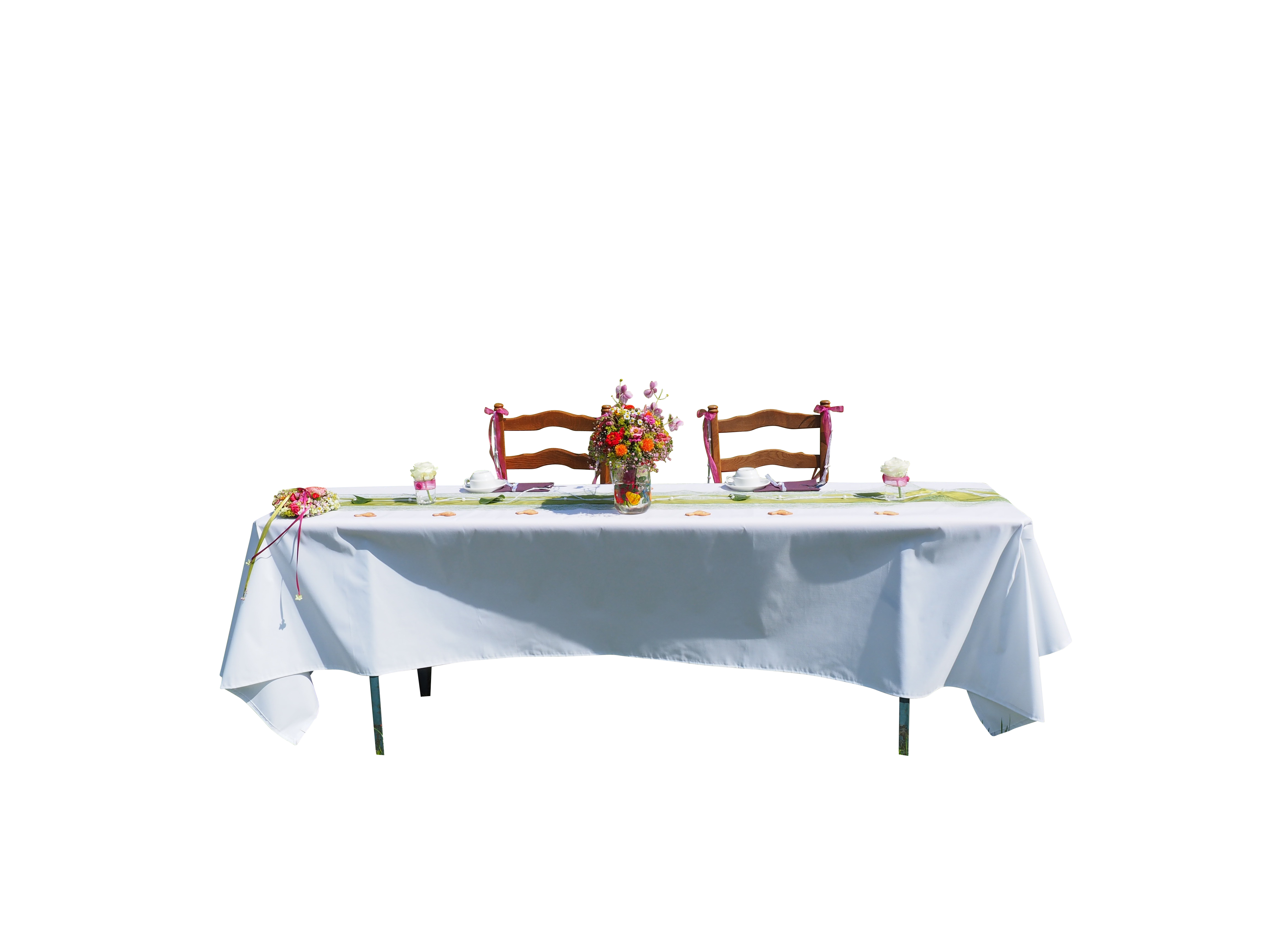 A Table With A White Tablecloth And Flowers On It