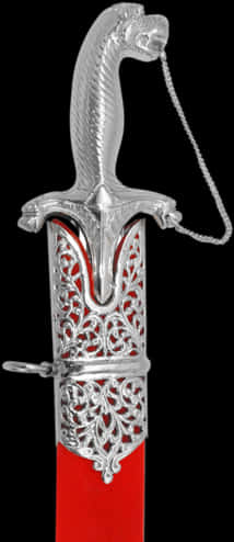 A Silver Sword Shaped Object With Red Inside
