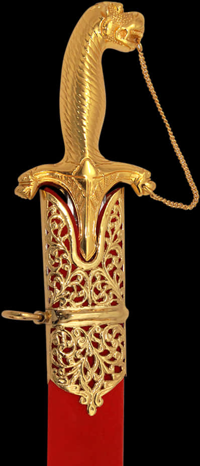 A Gold Sword Shaped Object With A Chain