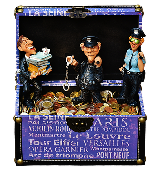 A Toy Police Officer And Police Officer In A Treasure Chest