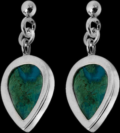 A Pair Of Earrings With A Green Stone