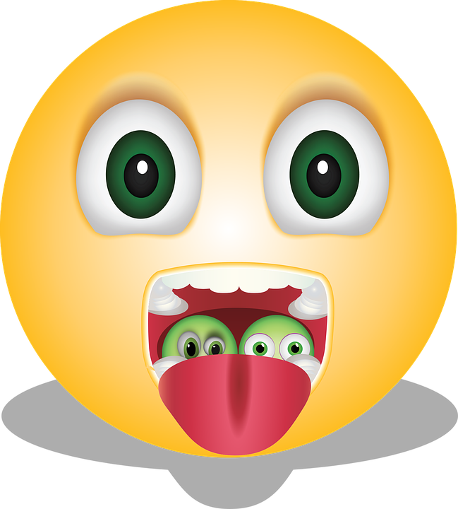 A Yellow Emoji With Green Eyes And Tongue Sticking Out