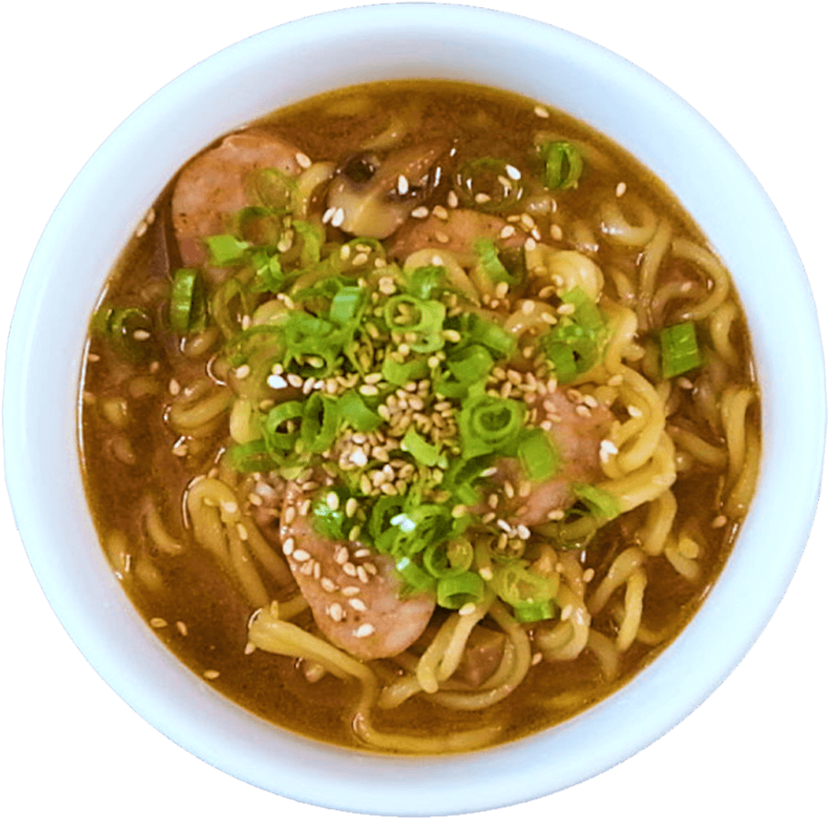 A Bowl Of Soup With Noodles And Green Onions