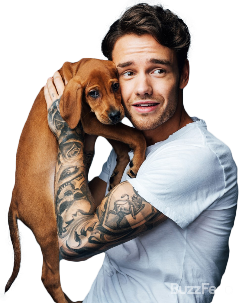 A Man With Tattoos Holding A Dog