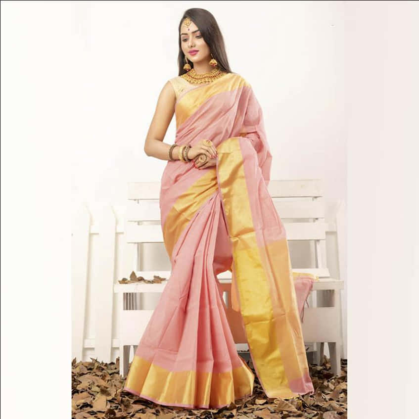 A Woman In A Pink And Gold Sari