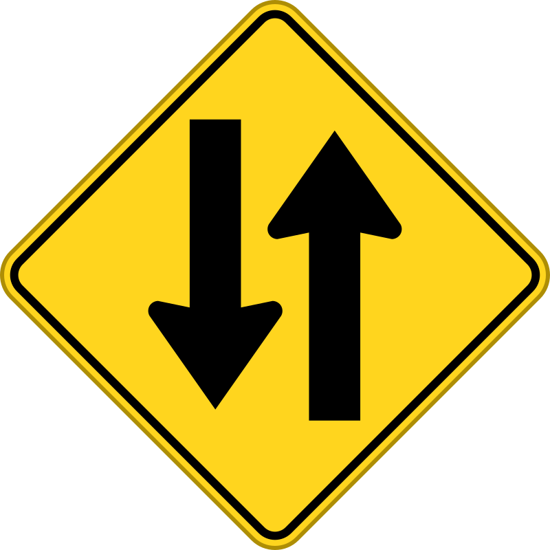 A Yellow Road Sign With Black Arrows