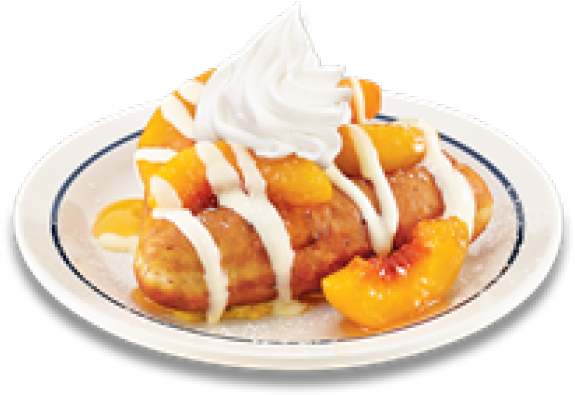 A Plate Of Food With Whipped Cream And Peaches