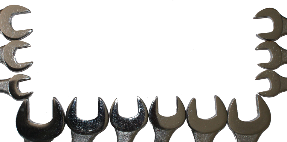 A Row Of Wrenches On A Black Background
