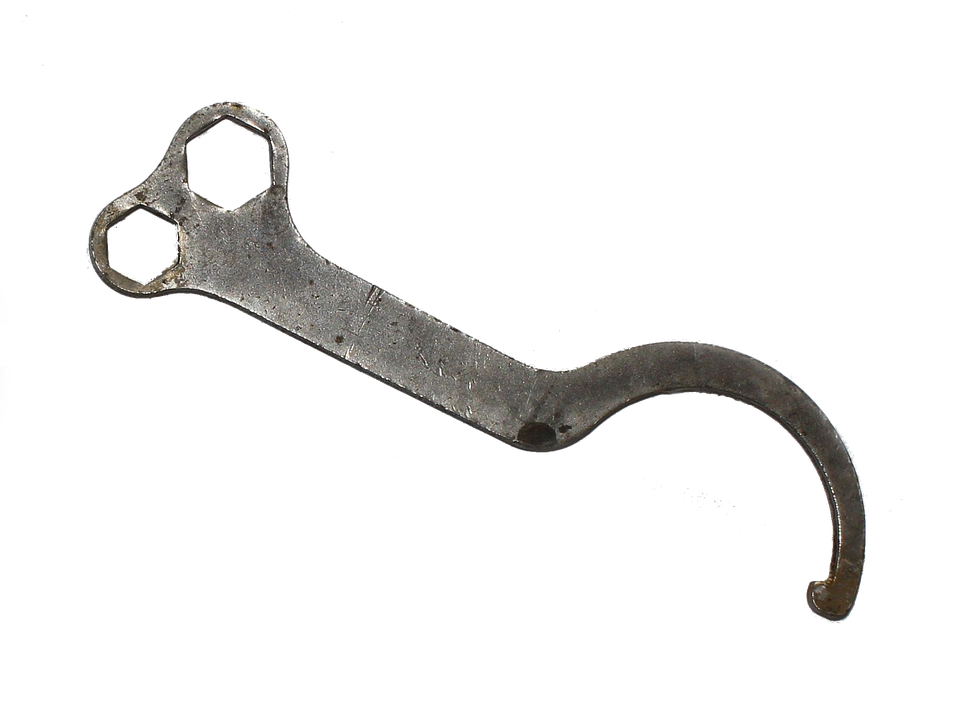 A Metal Wrench On A Black Background