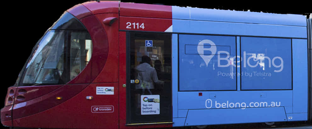 A Red And Blue Bus With A Person Entering The Door