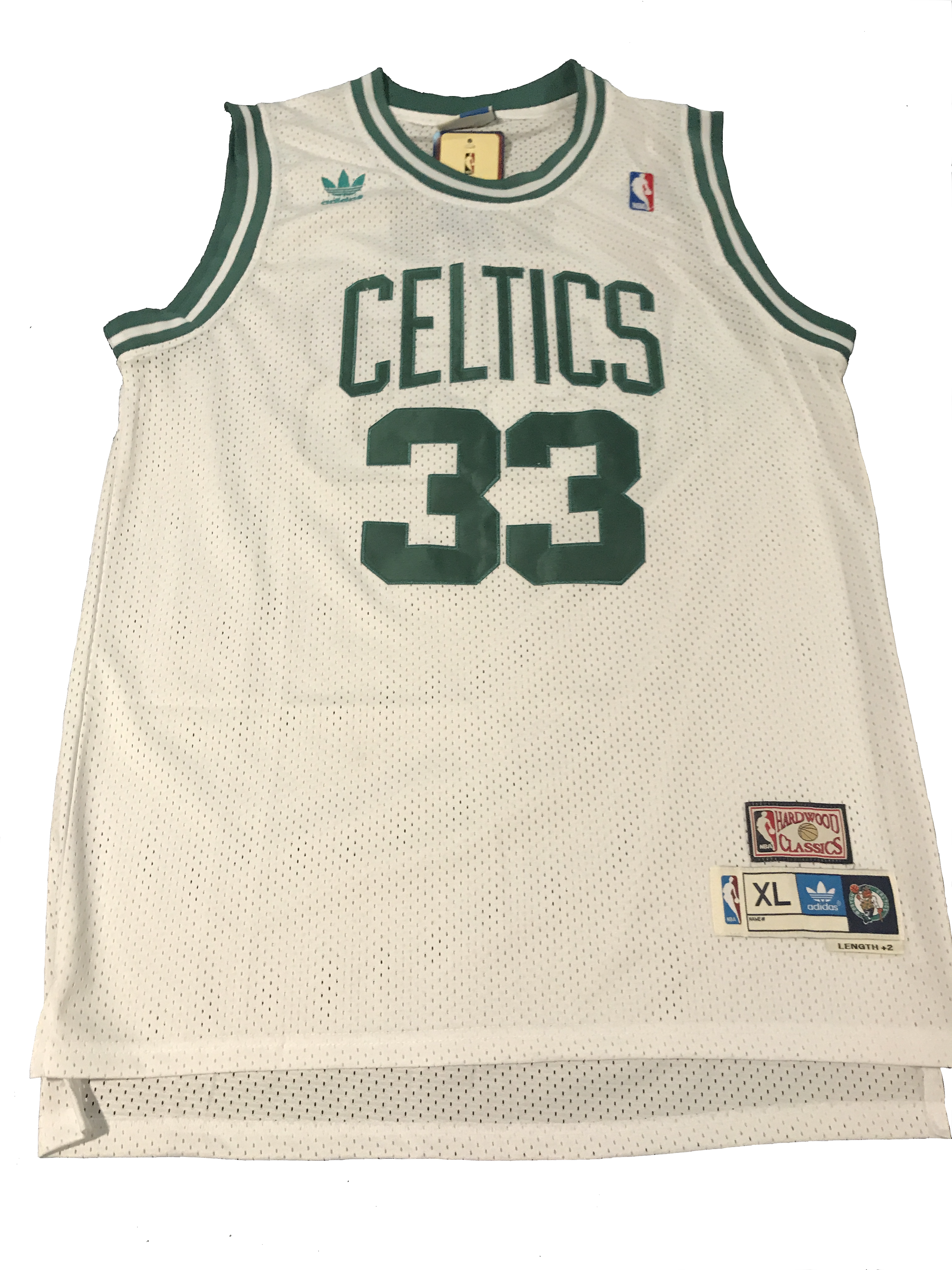 A White Basketball Jersey With Green Letters And Numbers