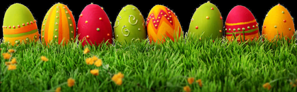A Row Of Painted Eggs In Grass