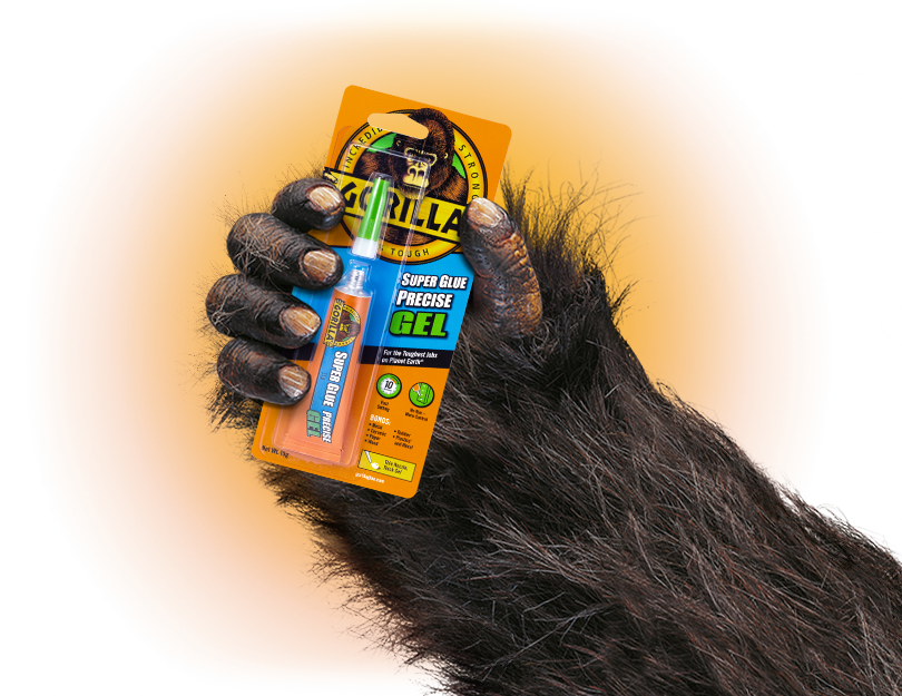 A Monkey's Hand Holding A Tube Of Glue