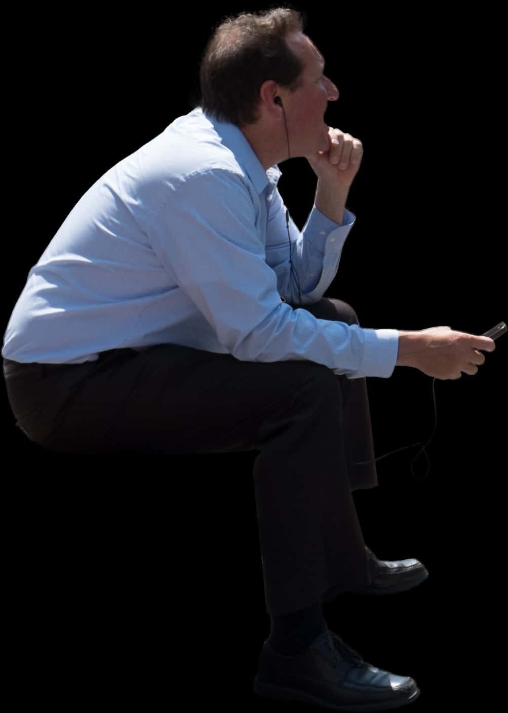 A Man Sitting And Holding A Phone
