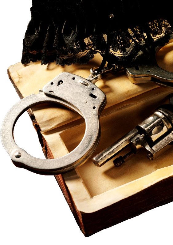 A Pair Of Handcuffs And A Gun On Top Of A Book