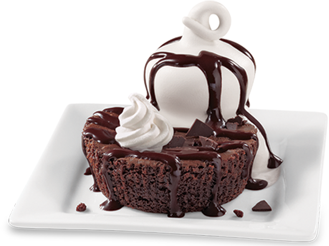 A Chocolate Dessert With Whipped Cream And Chocolate Sauce
