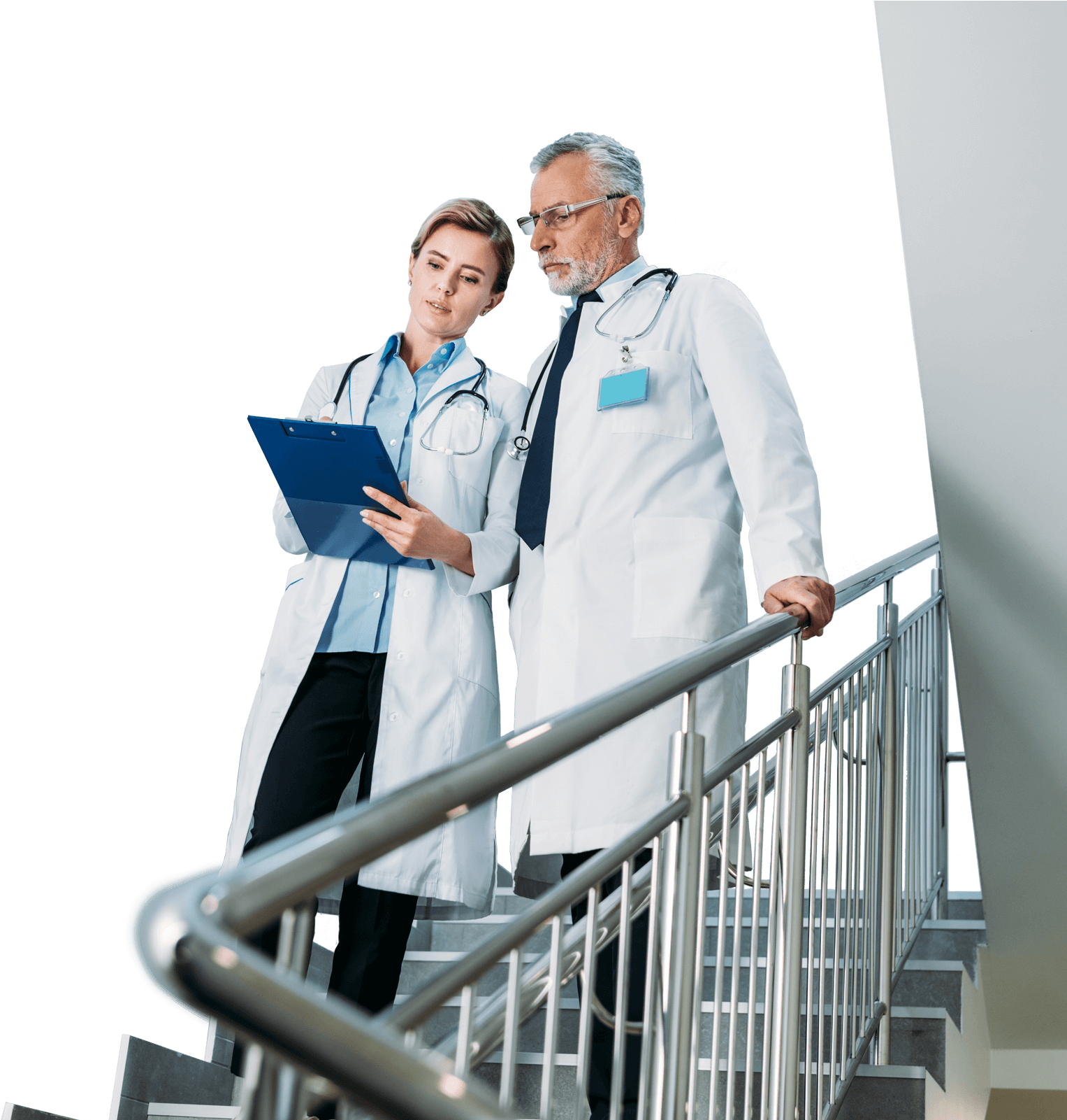 A Man And Woman Wearing White Lab Coats Standing On Stairs