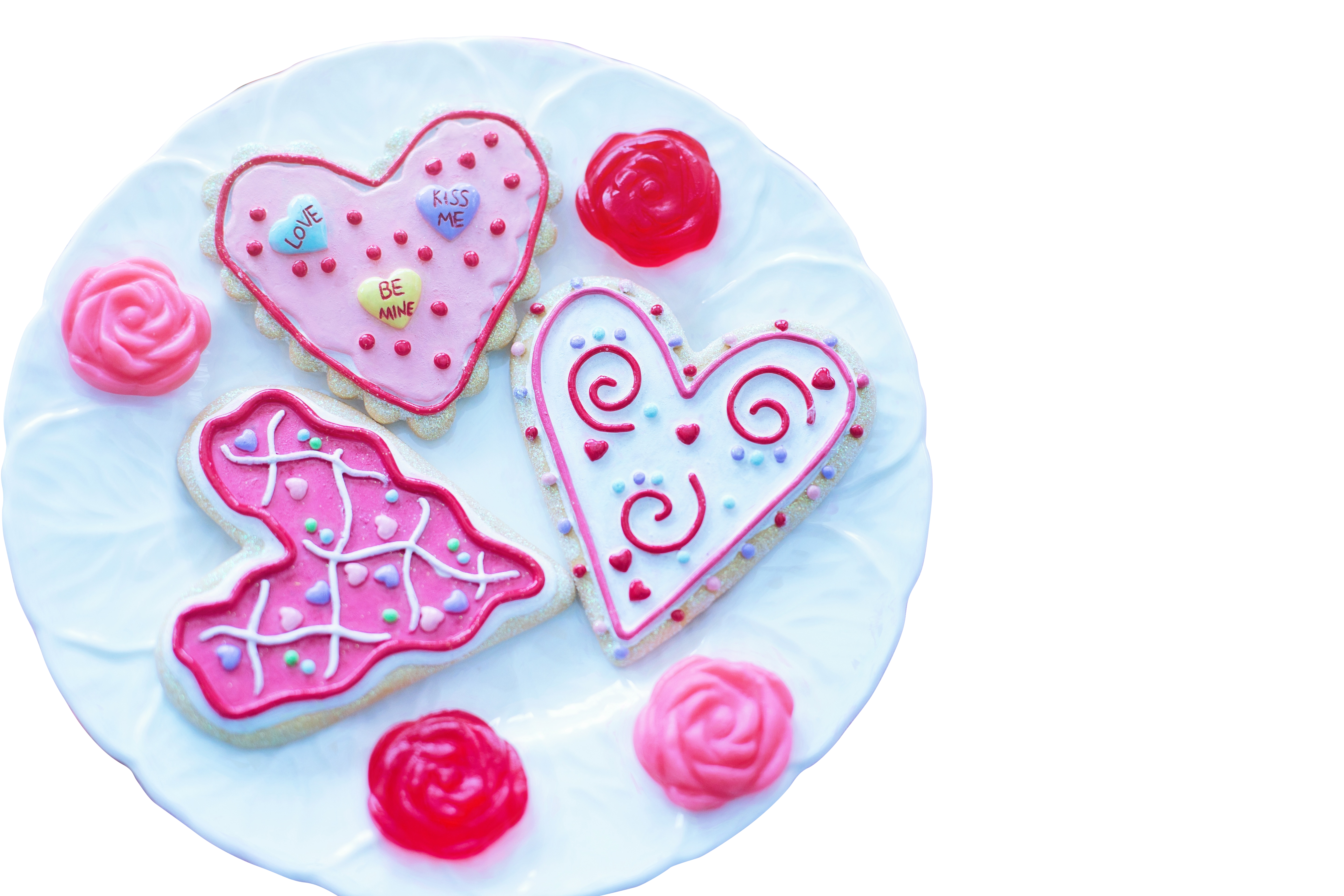 A Plate Of Cookies With Pink Frosting