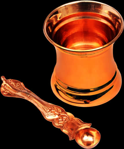A Copper Cup And Spoon