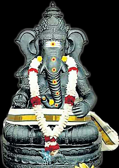 A Statue Of An Elephant With A Garland
