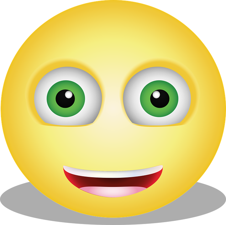 A Yellow Smiley Face With Green Eyes And A Smile