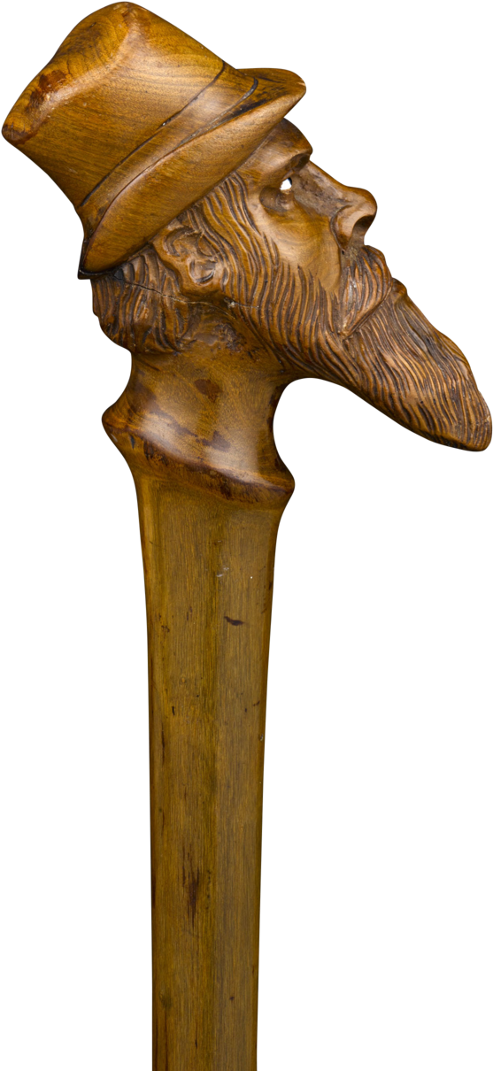 A Wooden Walking Stick With A Horse Head Carved On It