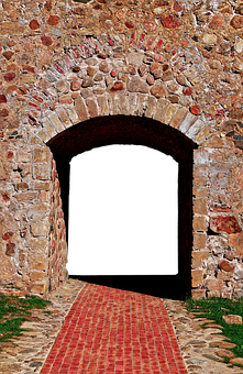 A Stone Archway With A Brick Walkway