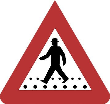A Red Triangle With A Sign With A Man Walking On It