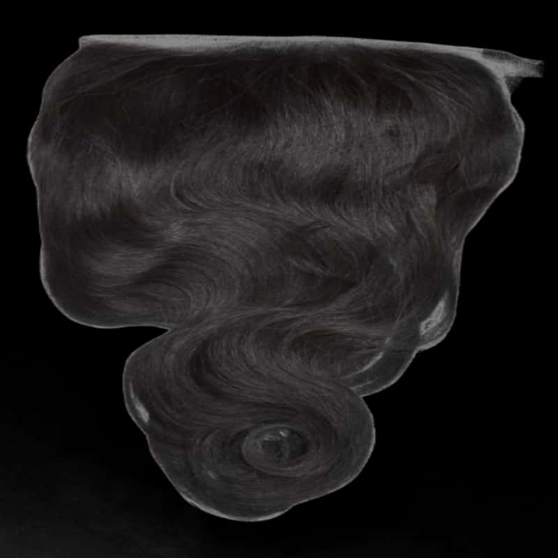 A Black Hair Piece On A Black Background