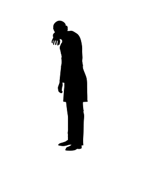 A Silhouette Of A Man With His Hand On His Face