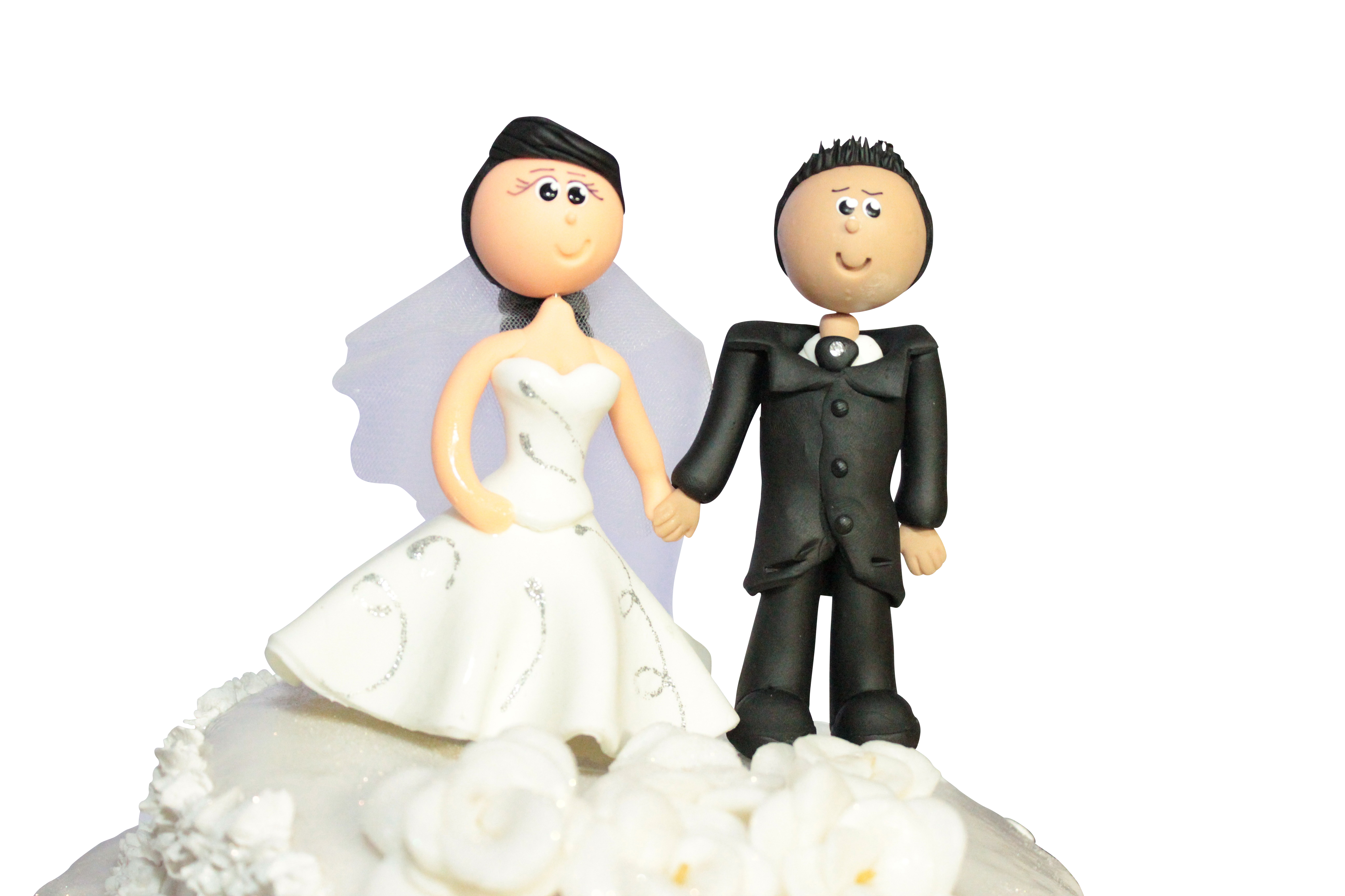 A Couple Of Figurines On A Cake Top