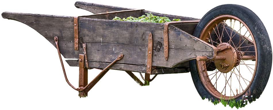 A Wooden Wheelbarrow With Plants In It