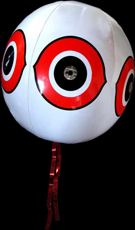 A White And Red Balloon With Black And Red Eyes