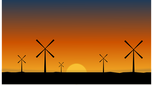 Windmills In A Field At Sunset