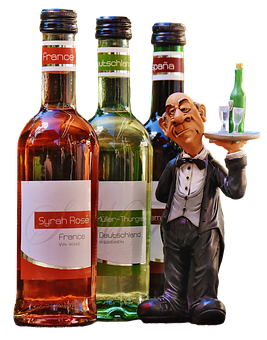 A Statue Of A Man Holding A Tray Of Wine