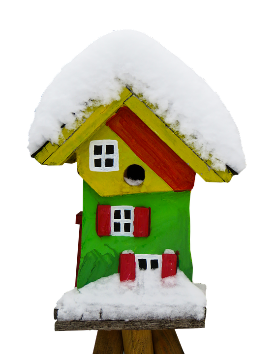A Colorful Bird House Covered In Snow